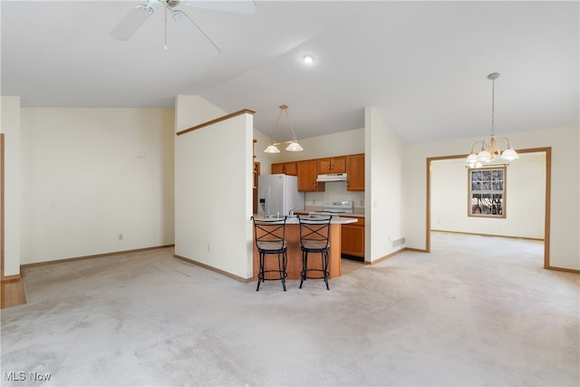 kitchen featuring pendant lighting, vaulted ceiling, white appliances, a kitchen bar, and a kitchen island