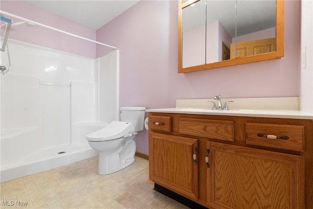 bathroom with a shower, vanity, and toilet