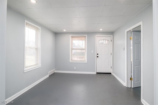 foyer featuring a paneled ceiling and a healthy amount of sunlight