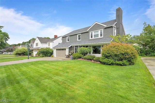 view of front of property featuring a garage and a front lawn