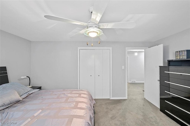 bedroom featuring a closet, ceiling fan, and light colored carpet