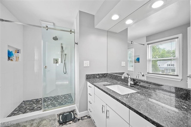 bathroom with vanity and a shower with shower door