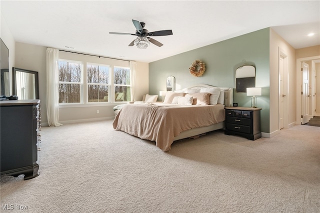 bedroom with light carpet and ceiling fan