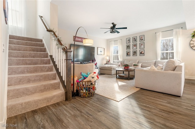 living room with ceiling fan and dark wood-type flooring