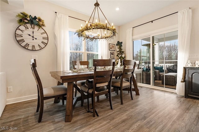 dining area with a notable chandelier and dark wood-type flooring