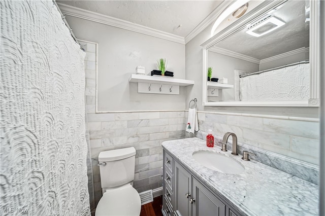 bathroom featuring vanity, crown molding, wood-type flooring, tile walls, and toilet