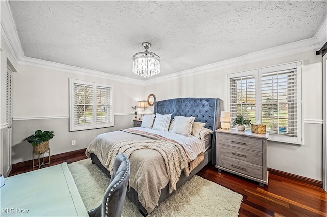 bedroom with multiple windows, dark wood-type flooring, and a textured ceiling