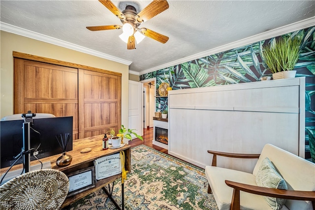 office space with a textured ceiling, ceiling fan, crown molding, and hardwood / wood-style floors