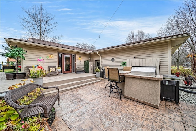 view of patio / terrace with exterior kitchen and an outdoor bar