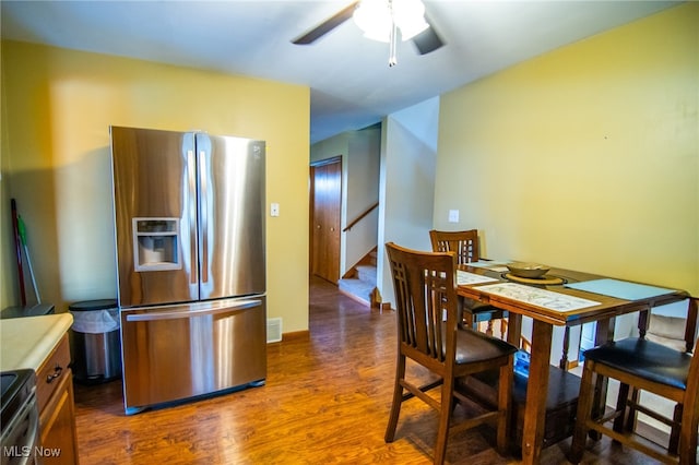 kitchen with ceiling fan, dark hardwood / wood-style flooring, and stainless steel appliances