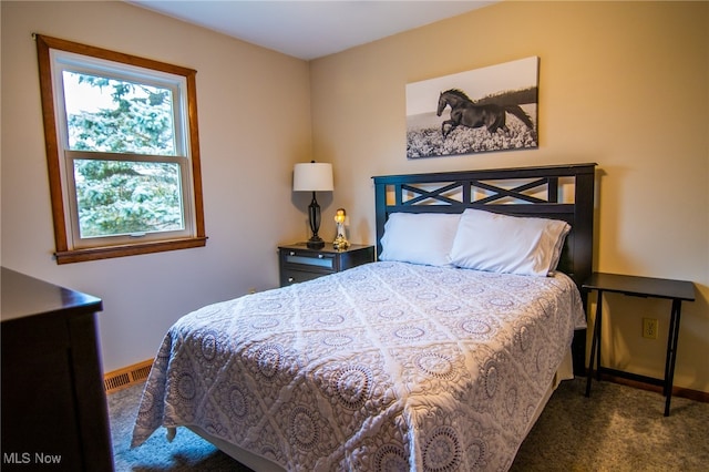 bedroom with dark colored carpet