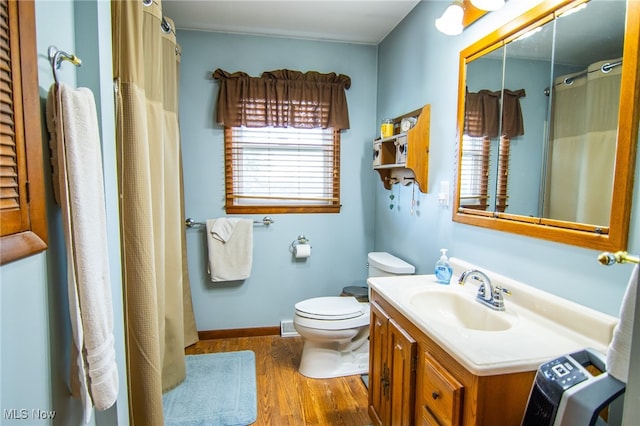 bathroom with hardwood / wood-style floors, vanity, and toilet