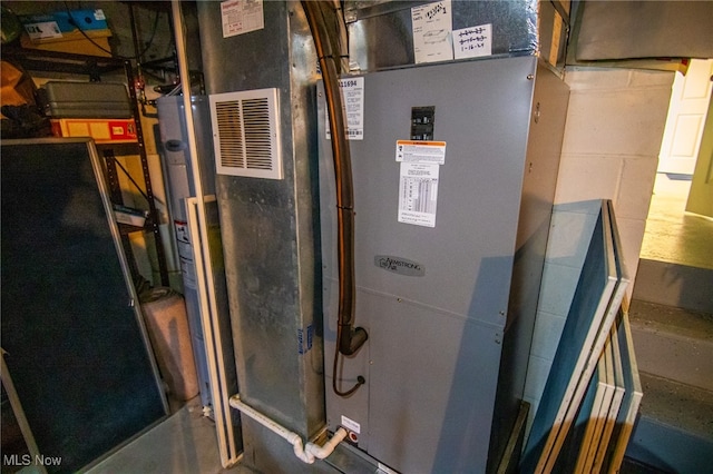 utility room featuring heating unit