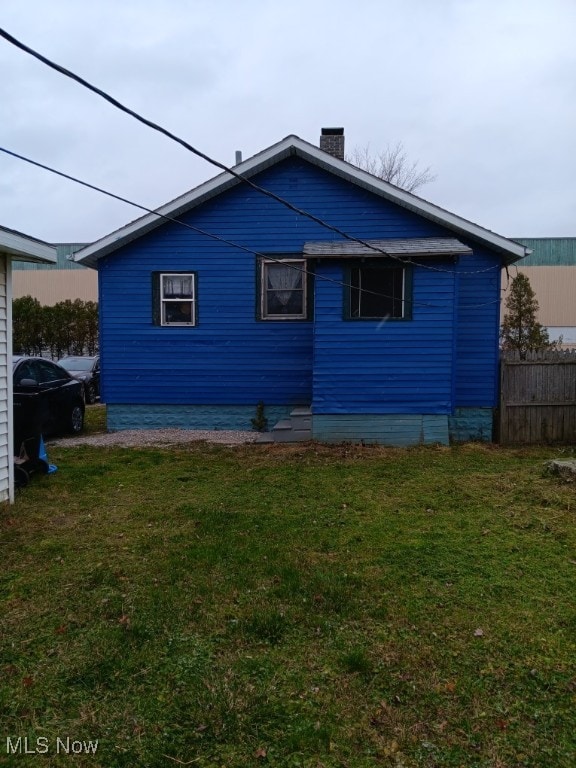 view of side of property with a lawn