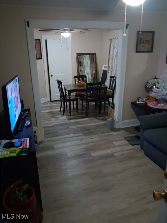 interior space with ceiling fan and wood-type flooring