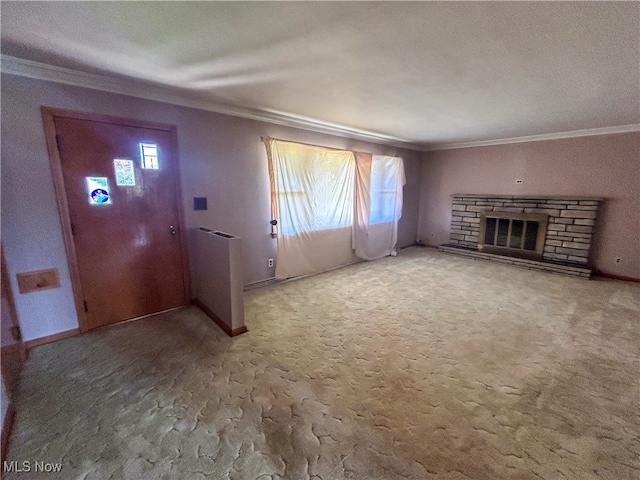 unfurnished living room with carpet flooring, a stone fireplace, and crown molding