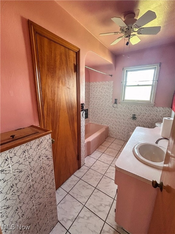 bathroom featuring vanity, shower / bath combination, and ceiling fan