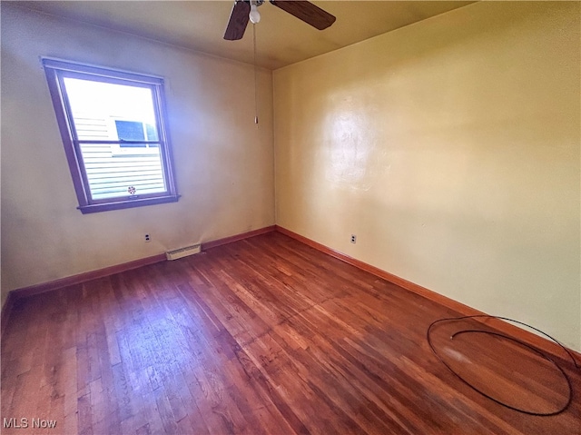 empty room featuring hardwood / wood-style flooring and ceiling fan