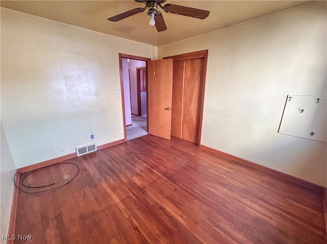 spare room with hardwood / wood-style floors and ceiling fan