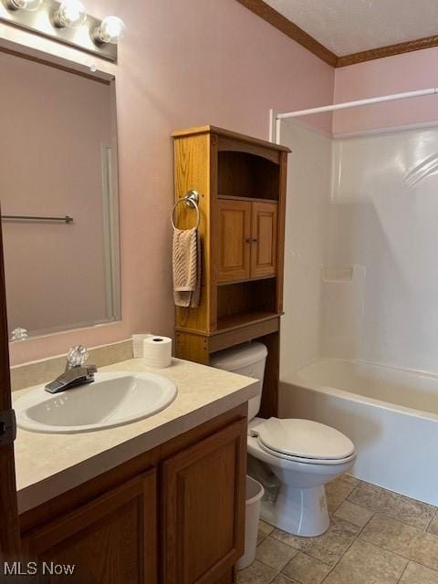 full bathroom featuring washtub / shower combination, tile patterned flooring, crown molding, toilet, and vanity