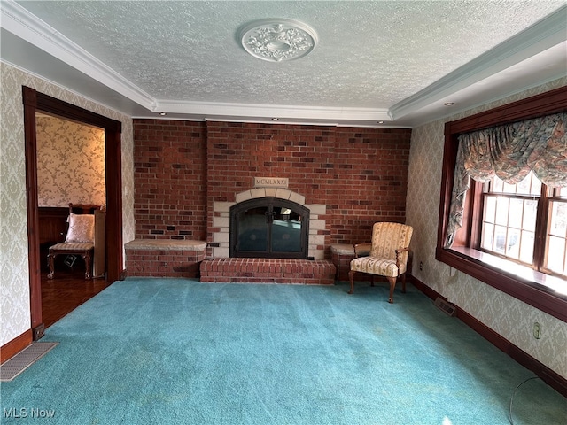 unfurnished room with a textured ceiling, carpet floors, and ornamental molding