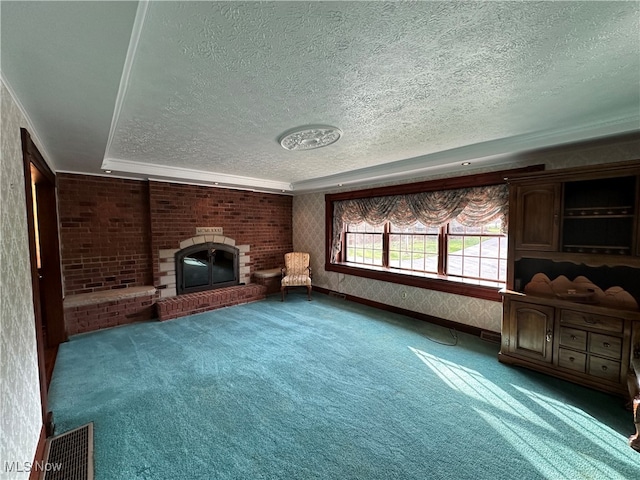 unfurnished living room with carpet, a textured ceiling, and a brick fireplace