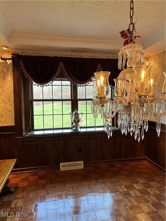 unfurnished dining area with wooden walls and a textured ceiling