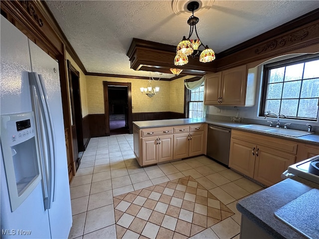 kitchen with dishwasher, white fridge with ice dispenser, sink, kitchen peninsula, and pendant lighting