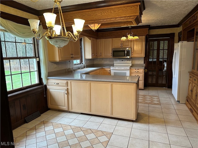 kitchen with kitchen peninsula, white appliances, light brown cabinets, light tile patterned floors, and an inviting chandelier