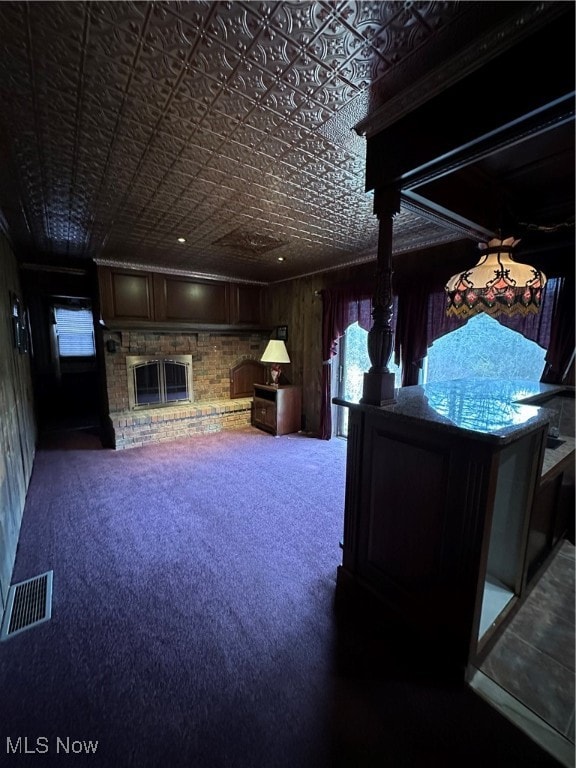 interior space with carpet floors and a brick fireplace