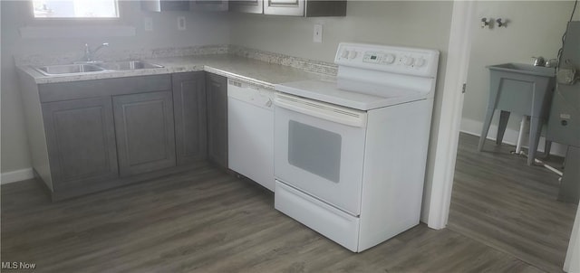 kitchen featuring white dishwasher, sink, electric stove, gray cabinets, and dark hardwood / wood-style floors