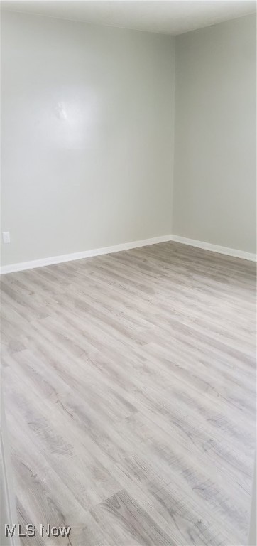 empty room with light hardwood / wood-style flooring