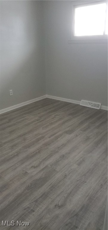 unfurnished room with wood-type flooring