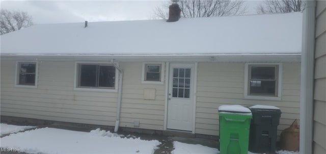 view of snow covered property entrance