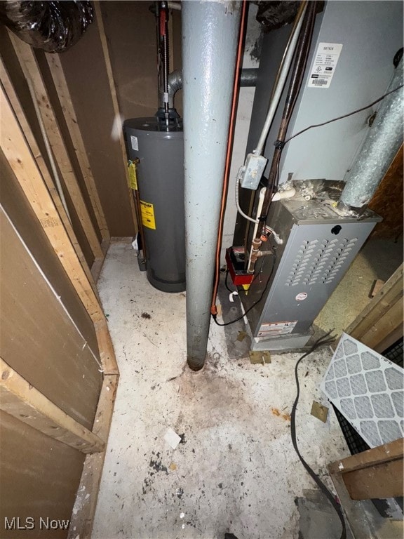 utility room featuring gas water heater and heating unit