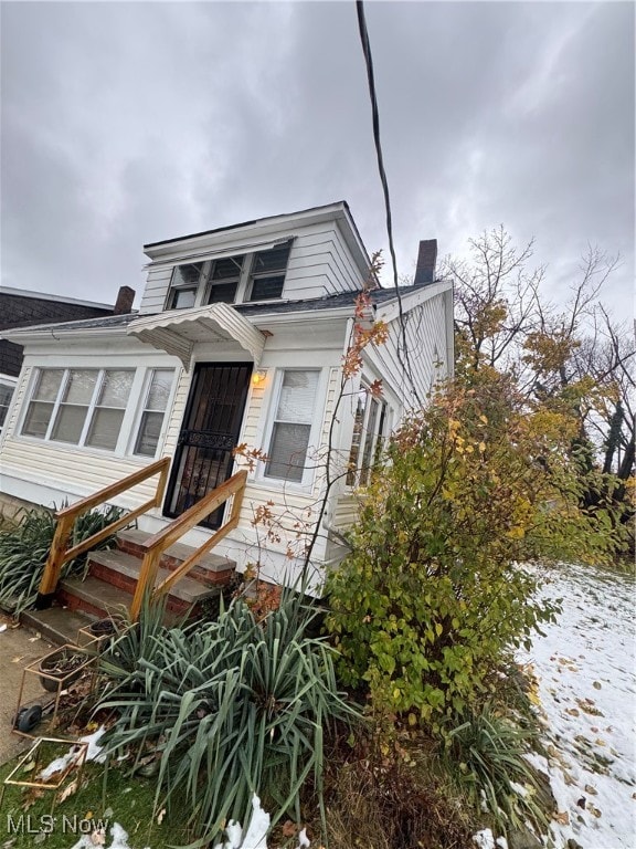 back of house with a sunroom