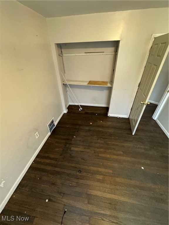 interior space with a closet and dark wood-type flooring