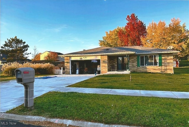 ranch-style home with a garage and a front lawn