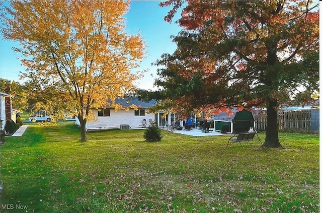 view of yard featuring central air condition unit and a patio