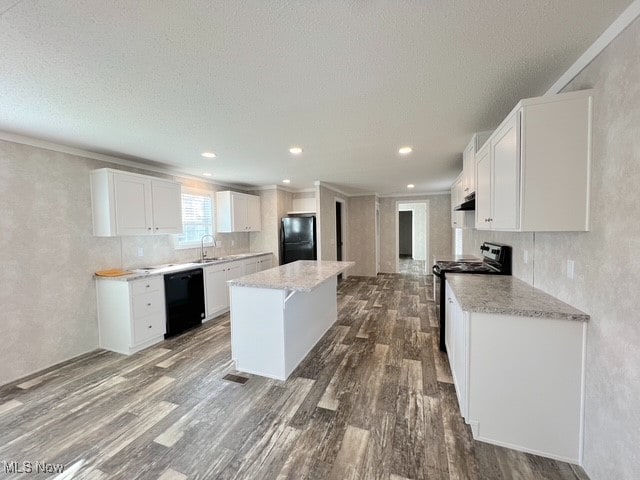 kitchen featuring a center island, white cabinets, black appliances, sink, and hardwood / wood-style flooring