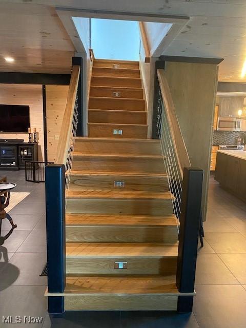 stairs featuring tile patterned floors