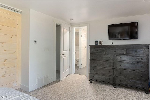 carpeted bedroom with connected bathroom