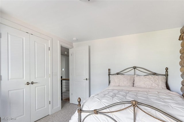 carpeted bedroom with a closet