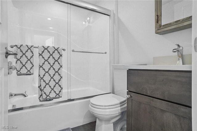 full bathroom featuring shower / bath combination with glass door, vanity, and toilet