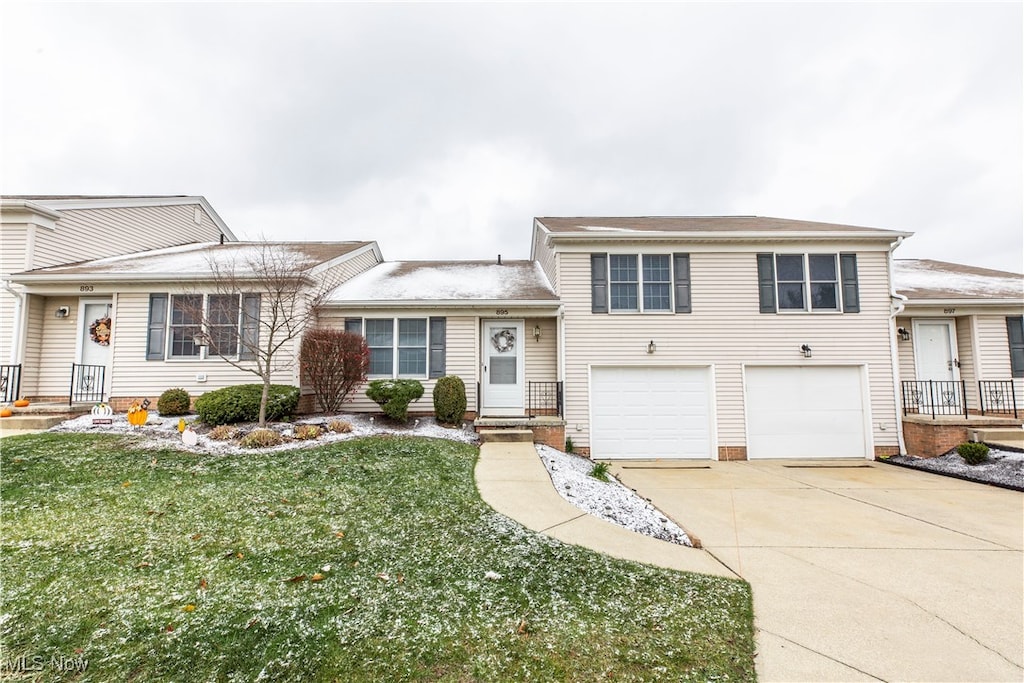 tri-level home with a garage and a front yard