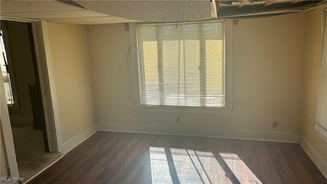 spare room with dark hardwood / wood-style floors