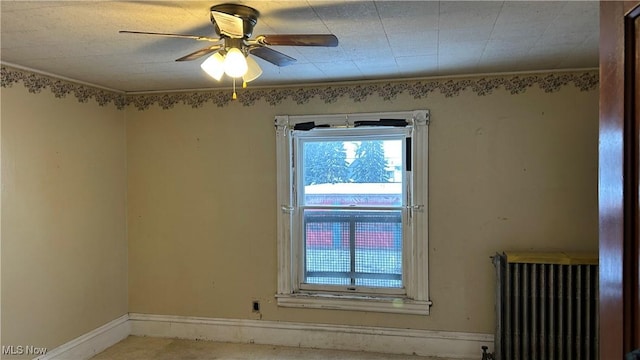 unfurnished room with ceiling fan, radiator heating unit, and ornamental molding