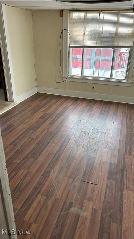 spare room with dark hardwood / wood-style flooring