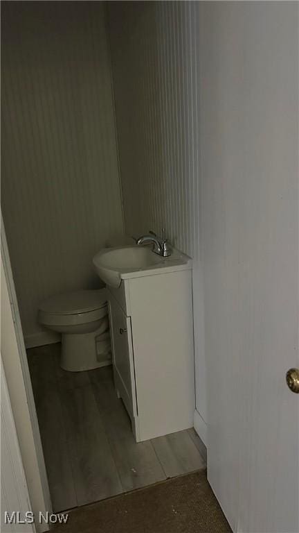 bathroom featuring toilet and vanity