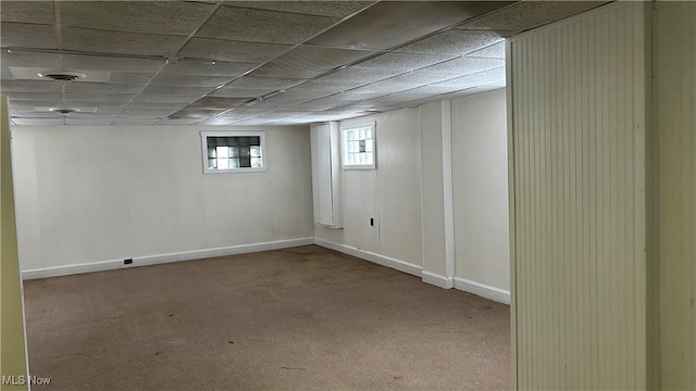 basement with carpet and a drop ceiling